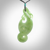 This pendant is a beautiful large New Zealand Inanga jade manaia pendant with koru. It has the head of a bird and the tail of a fish and also two koru carved into the body. It is carved by Ross Crump here in New Zealand. Provided with an adjustable Black cord.